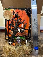 Front view showing haunted tree scene, figures, ruler for scale