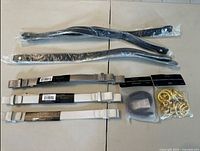 All straps and accessories laid out: black, taupe, cream straps, grey strap, gold rings