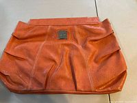 Front view of orange Miche Prima Savannah shell