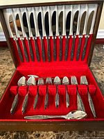 Open wooden chest showing knives, forks and spoons