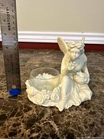 Front view with ruler showing height approx 5.5 in