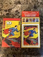 Front covers of both stamp booklets showing Superman artwork and product details