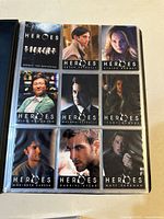 Binder page with nine base set cards including title card and character cards for Peter Petrelli, Claire Bennet, Mohinder Suresh, Isaac Mendez, Gabriel Gray, Matt Parkman