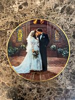 Front of decorative plate showing bride and groom image with gold rim