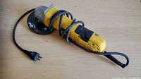 Full view of DeWalt corded angle grinder with cord and plug