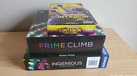 Stacked view of Prime Climb, Pandemic: Contagion, Ingenious game boxes