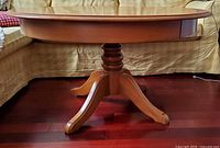 Side view of entire table showing pedestal base and lowered height