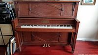Full view of Mason & Risch upright grand piano with keyboard, pedals and front panel visible