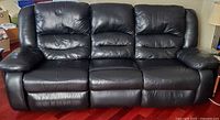 front view of black three-seat reclining sofa upright