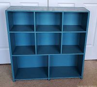 Front view of blue cube bookcase showing all compartments
