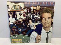 Front cover of “Sports” LP showing artwork and overall condition