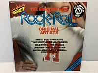 Front cover of ‘The Greatest Hits of Rock and Roll’ LP showing title, Impact logo, song list, catalog number