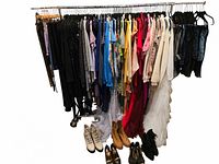 full rack of clothing and footwear on floor