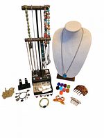 Group shot showing all jewelry and accessories arranged with necklace display, stand, rings, combs, scarf