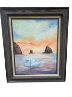 Front view of framed oil painting showing boat, sunset, rocks