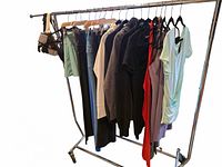 Full rack of clothing showing variety of garments on hangers