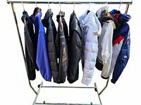 Eight jackets hanging on rack showing variety of colors and styles