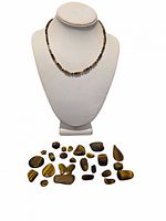 Necklace displayed on bust with array of tiger’s eye stones