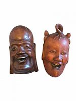 Front view of both wooden masks showing faces