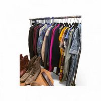 Garment rack with assorted clothing and two pairs of boots visible