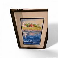 Framed watercolor lighthouse painting front view