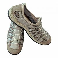 Side and angled view of both shoes showing leather upper, floral panels, elastic laces