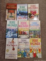 Group shot of all nine paperback novels front covers visible
