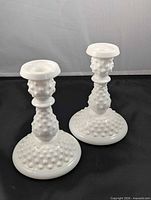 Pair of white hobnail milk glass candlestick holders front view