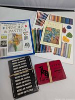 Lot overview with two books and two Reeves pastel sets