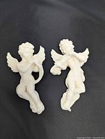 Front view of both resin cherub wall hangings