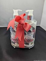 Front view of two Kingston Hill Camellia bottles with ribbon and stand