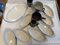 Group shot showing all items: Pyrex baker, seven ceramic bakers, four mugs, Hull bowl