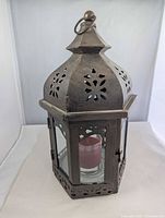 Full view of hexagonal metal lantern with ring hanger