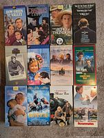 Front view of all 12 VHS tapes showing titles and cover art