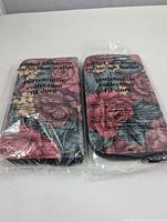 Two Avon wallets sealed in original plastic packaging