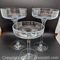Three clear glass pedestal candle stands displayed together