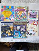 All six rubber stamping books laid out showing full covers