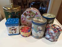 Group shot of all seven tins showing variety of shapes and designs