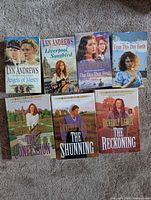 Seven fiction books laid out showing all covers