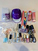 Entire lot laid out: dryer, 11 polishes, files, buffers, scissors, cotton swabs