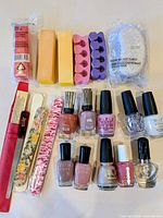 Full lot overview showing nail polishes, files, buffers, toe separators, pumice