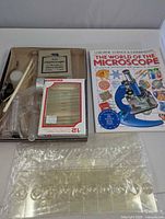 Book, prepared slide set, blank slides, vials and pipettes displayed