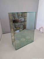 Front view of mirrored glass candle holder with LED tealights visible