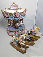 Overall view of musical carousel with three separate rocking horses