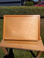 Front view of adjustable wooden easel board on tabletop