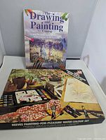 Front view of book and closed Reeves watercolour set box