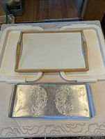 All four trays grouped: wood, two plastic, aluminum