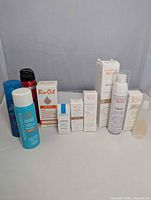 All boxed skincare, three travel hairsprays, perfume vial overview