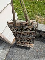 Front view of tote cart showing woven tapestry animal print design, straps, overall shape