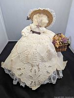 Rear view of doll showing full crochet lace overskirt and bonnet
